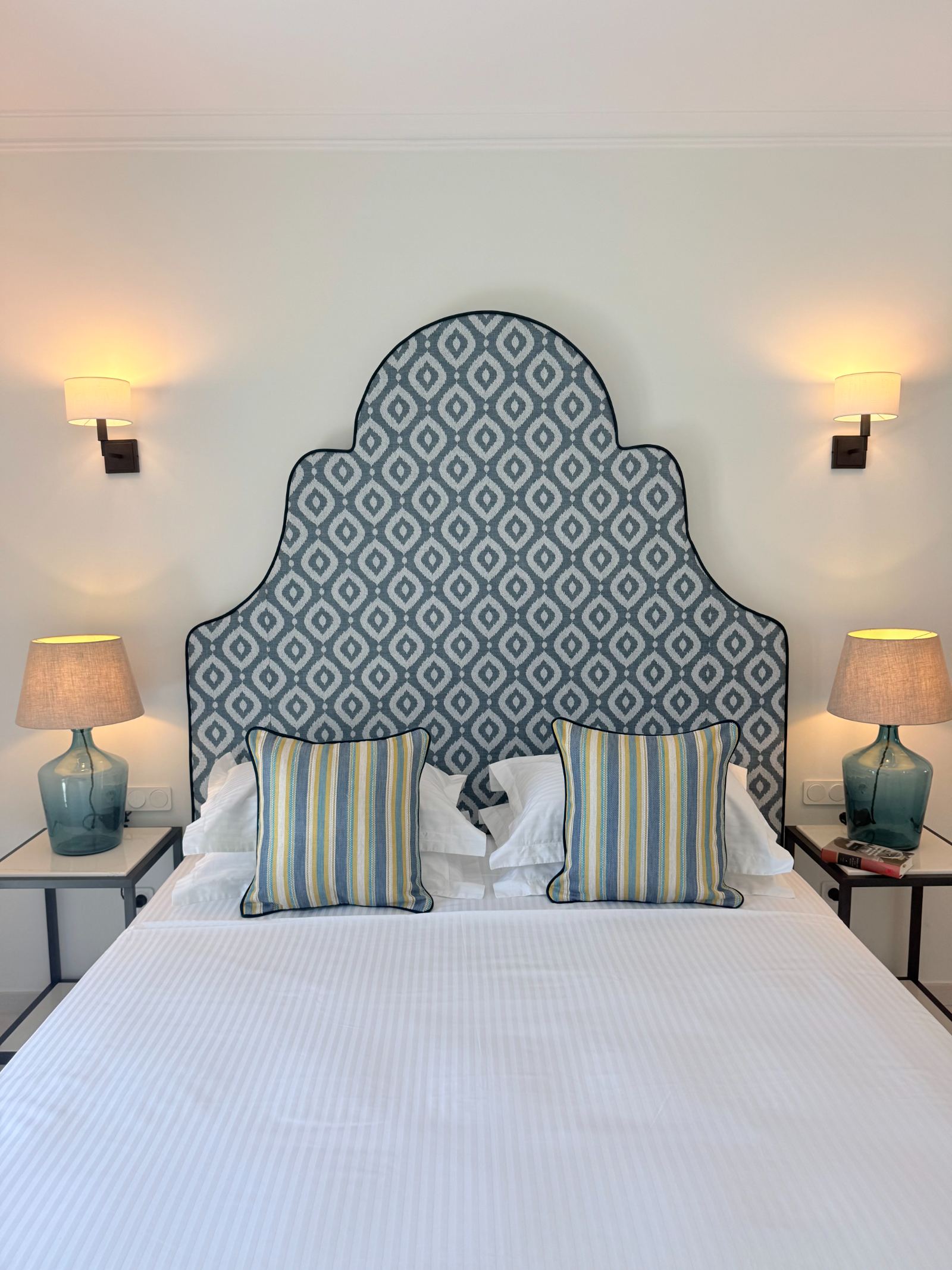 Double bedroom with blue ikat upholstered headboard