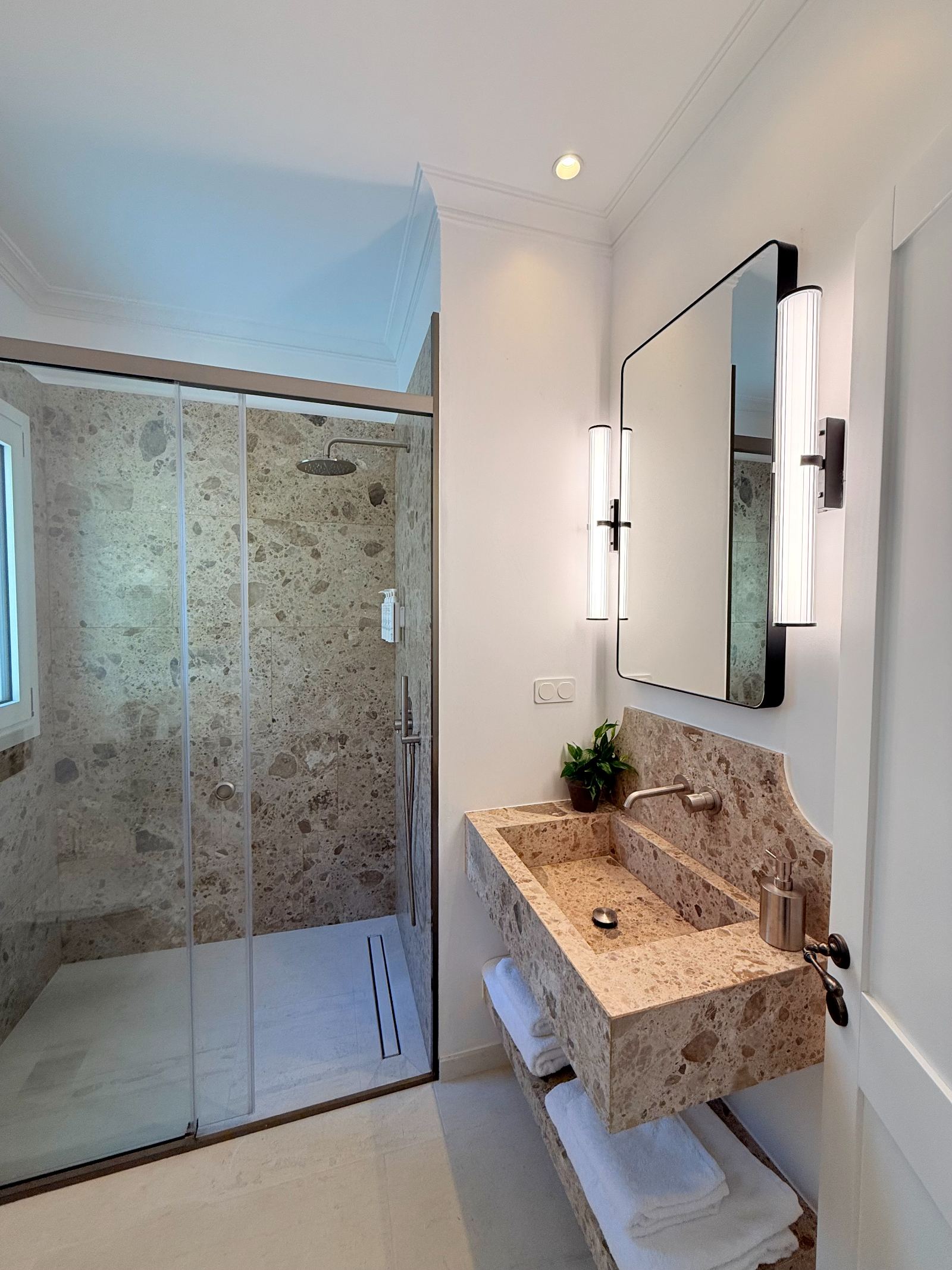 Bathroom with stone vanity and rain shower