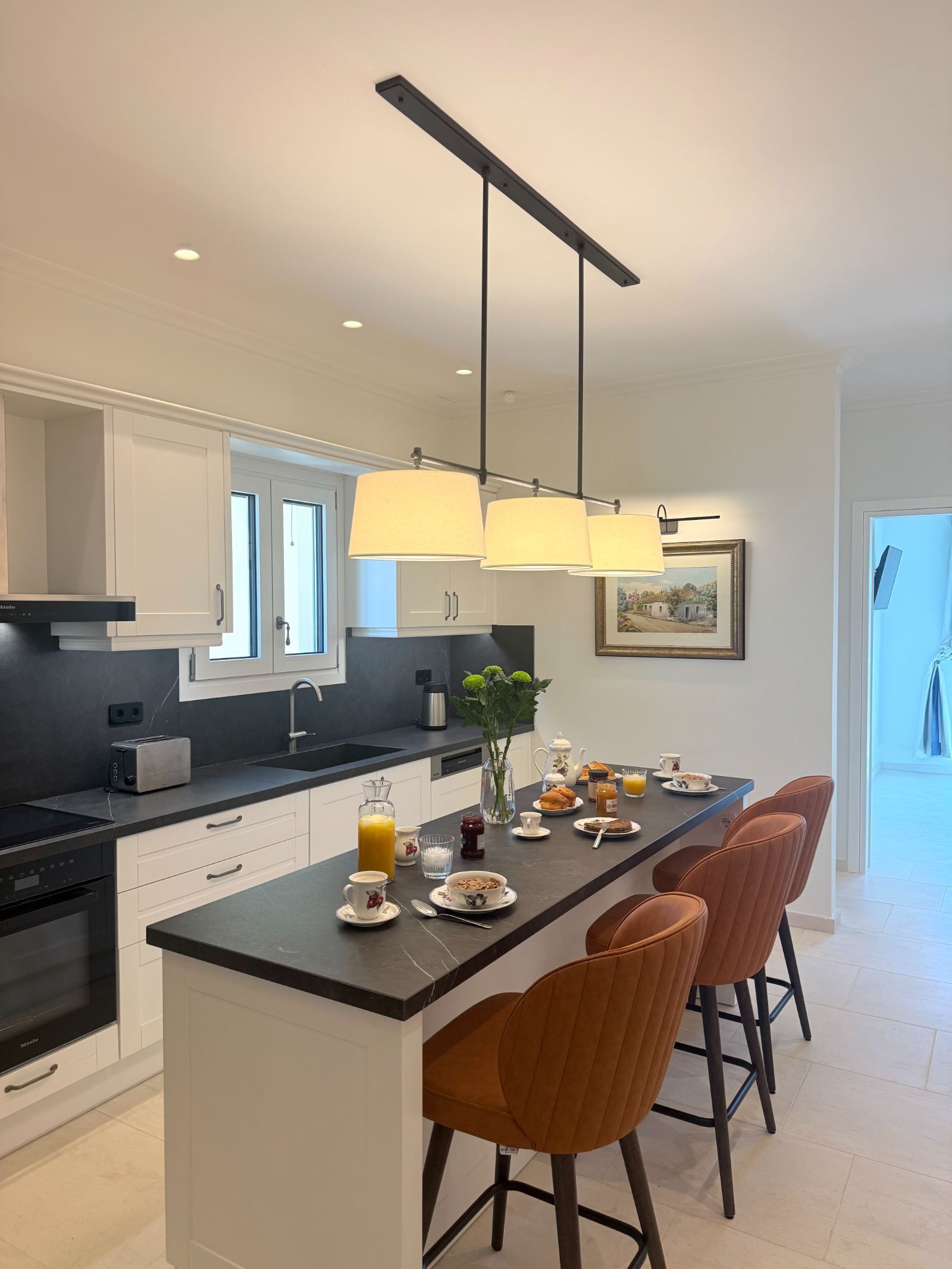 Kitchen island set for breakfast with Miele appliances