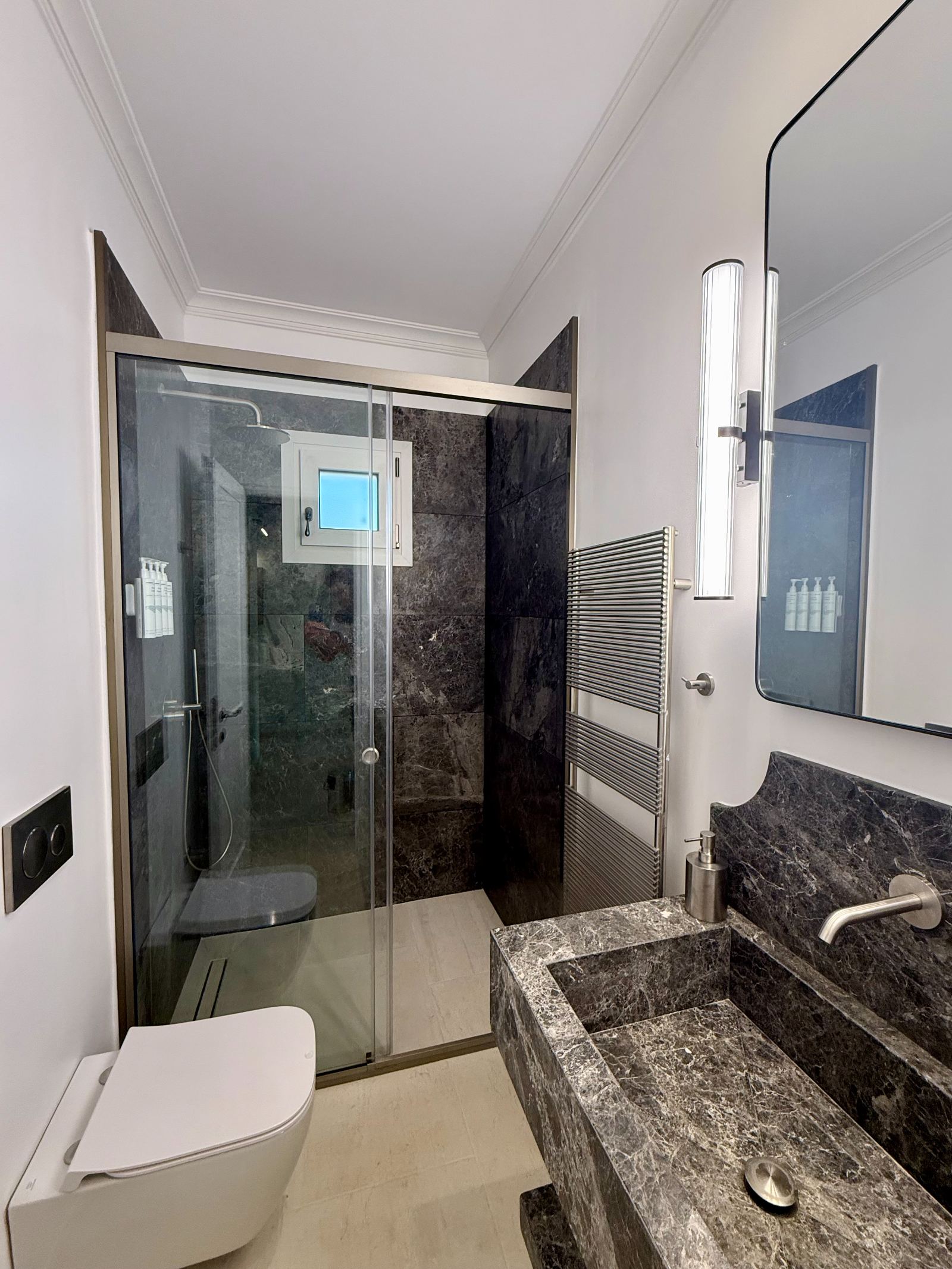 Third bathroom in dark marble with heated towel rail